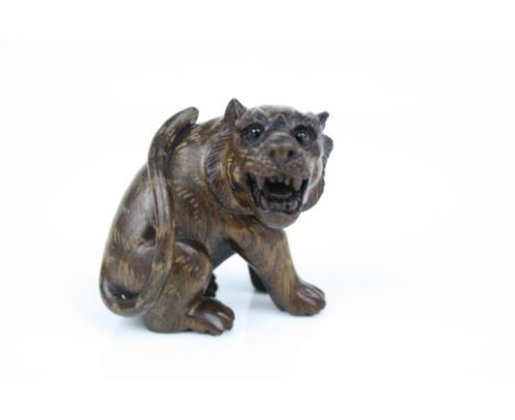 Carved wooden netsuke in the form of a tiger 