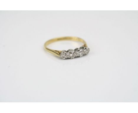 A four stone 18ct gold diamond ring. (UK Size Q).