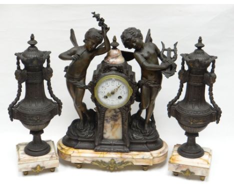 A French spelter and pink marble clock garniture. With two dancing cherubs flanking the raised time-piece with concave white 