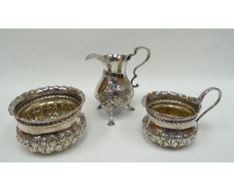 A silver cream jug and matching sugar basin having continuous raised acanthus decoration to the body and rope twist borders, 