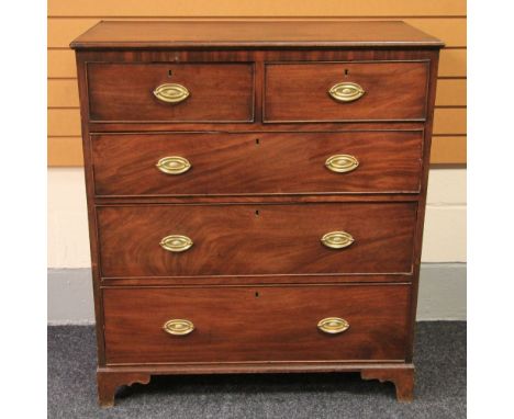 A mahogany chest of three graduated drawers and two short, brass furnished and on bracket feet, 102cms