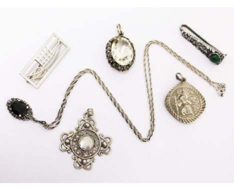 A mixed lot comprising a hallmarked silver pendant by Georg Jensen and another, a silver and jet pendant on chain, a brooch, 