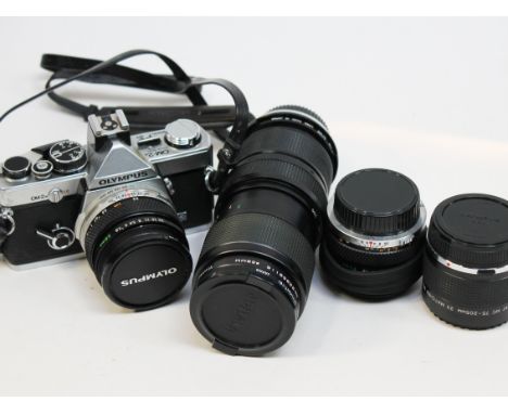 An Olympus OM-2 camera and four lenses
 
Condition - generally good, all mechaincal parts apear to be working correctly, a li