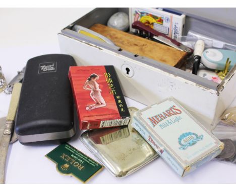 A tin of various items including coins, playing cards, penknives, badges, cigarette case etc.