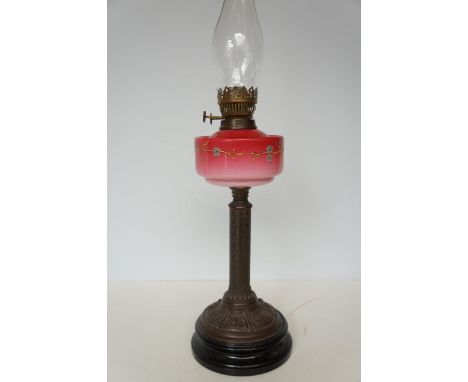 Victorian oil lamp with enamelled floral design to reservoir