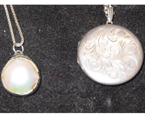 Silver locket together with a half cut mother of pearl stone pendant