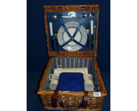 A vintage wicker picnic hamper complete with contents.