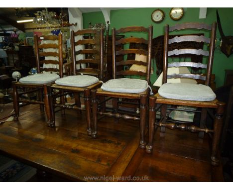 A set of four mixed woods, ladder-back Dining Chairs having woven sea-grass seats, turned legs, back supports and cross front