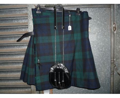 A "Kilt Society" kilt in navy, blue and green tartan, size 34-36 with Scottish dagger pin and sporran.