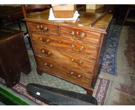 A charming compact Mahogany Chest of Oak construction with three long and two short Drawers, having highly polished brass dro
