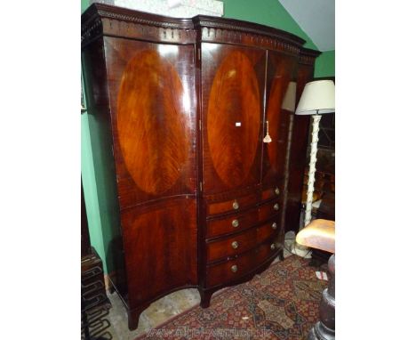 An imposing, good quality Oak carcassed, concave and convex fronted break-front Mahogany Wardrobe having a pair of doors to t