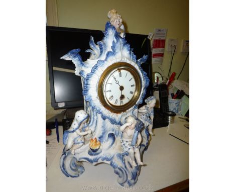 An attractive, probably continental porcelain mantel Clock, white ground and with vivid blue highlighted foliage and scrollwo