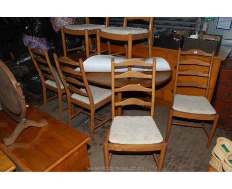 A set of six "Ercol" ladder-back Ash wood framed Dining Chairs and a matching oval Dining Table standing on turned legs havin