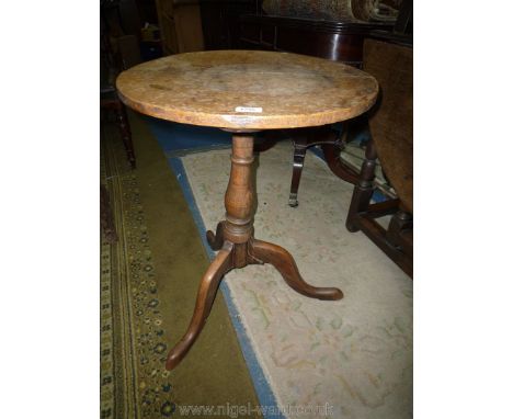 A mid Oak circular occasional table standing on turned pillar with three splay feet, 19 5/8'' diameter x 16'' high.