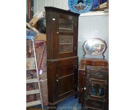 A peg joined 19th c. dark Oak corner display Cabinet on Cupboard base having two glazed panels to the upper section revealing