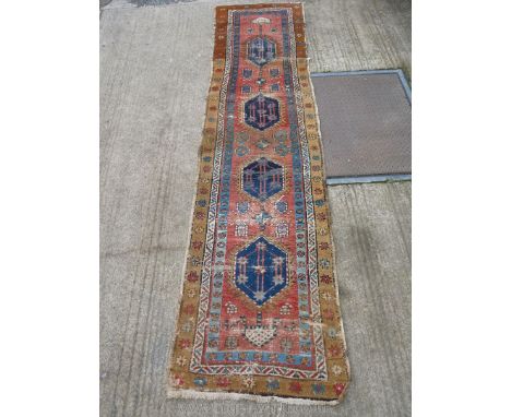 A long runner with brown floral border and four diamond shapes to the centre panel, very worn, 134'' long x 34'' wide.