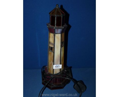 A Tiffany style lamp in the form of a lighthouse.