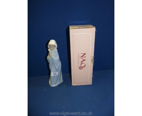 A Nao model of a young novice Nun praying., boxed, 11'' tall.