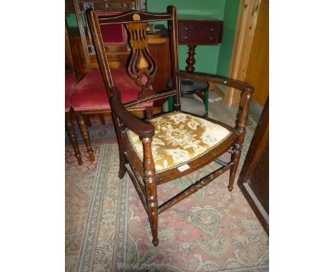 An Edwardian dark Mahogany and satinwood Elbow Chair, the fret-worked splat with inlaid decoration and light coloured stringi