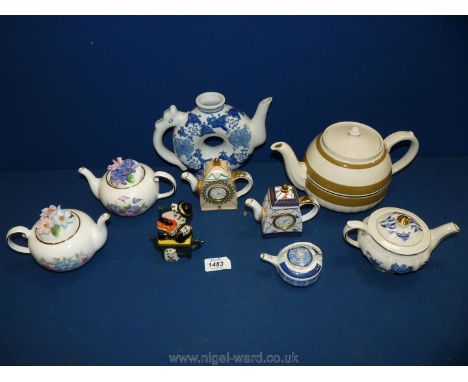 A small quantity of ornamental teapots including two 'Country cottage teapot collection' by Royal Stratford, oriental teapot,