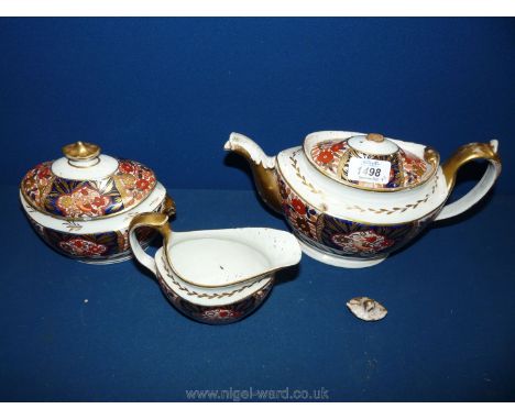 A trio of Crown Derby Tea ware comprising teapot, jug and sugar bowl with lid, in rust, dark blue and gilt decoration Imari s