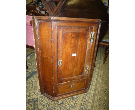 A compact circa 1800 Oak Corner Cupboard having brass 'H' hinges and unusually with a drawer below the door. 25 1/2'' wide x 