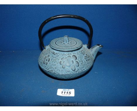 A heavy metal Japanese teapot with strainer, embossed with floral decoration, 6'' tall