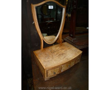 A light Walnut Swing Mirror having a bow-fronted three-drawer base and shield-shaped mirror. 16'' wide x 13'' deep x 21'' hig