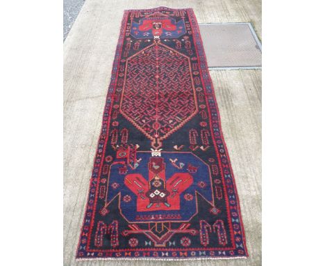 A large Iranian runner in red and black with blue border with geometric design, 44'' wide x 142'' long.