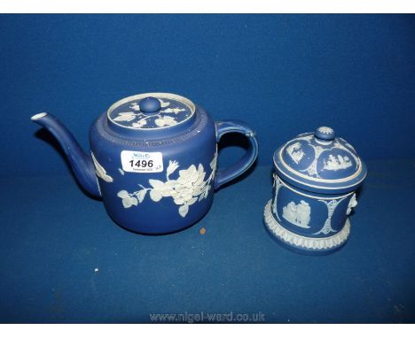 A Wedgwood Jasperware lidded pot in dark blue (crack to lid), 5 1/2" tall with a Jasperware style Teapot in dark blue with bi
