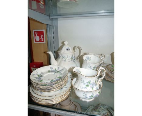 A Paragon part Teaset in 'Forget Me Not' design : four cups, six saucers and tea plates, cake plate, milk jug, sugar bowl and