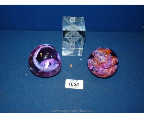A glass Celtic cross paperweight and two Caithness 'Brimstone' and 'Pebble' paperweights.