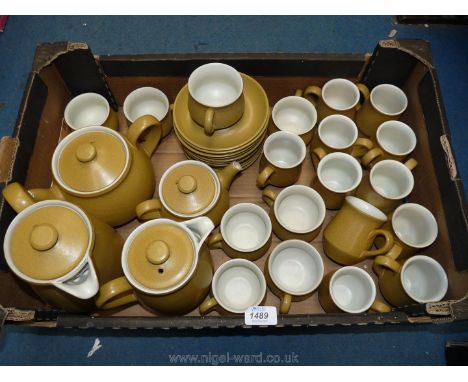 A Denby part coffee and part Teaset in a grainy mustard colour to include eleven coffee cups, seven tea cups, twelve saucers,