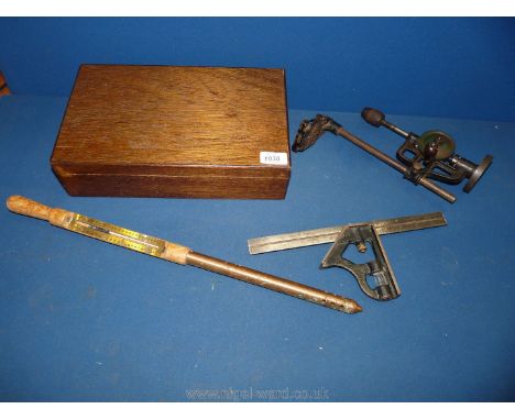 A vintage ground thermometer, wrought iron tower drill and set square in wooden box.