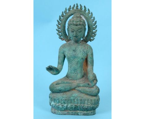 A Cambodian bronze Buddha, seated, on a lotus leaf base, 24 cm high  See illustration