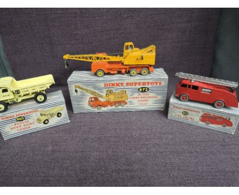Three Dinky diecasts, 955 Fire Engine with Extending Ladder, 965 Euclid Rear Dump Truck and 972 Coles 20 Ton Lorry Mounted Cr