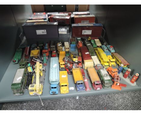 A shelf of playworn Dinky, Corgi, Matchbox and similar diecasts, Military, Construction, Car Transporters etc