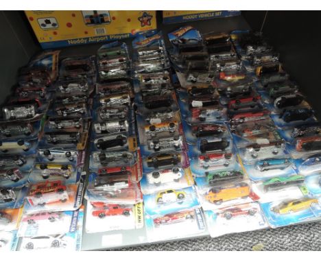 A shelf of modern Mattel Hotwheels diecasts, approx 63 all on bubble cars, some opened