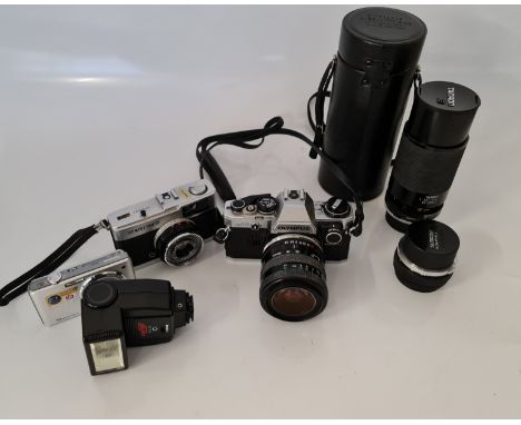 A Olympus om 10 camera three Tamron lenses Olympus Trip 35 and a Lumix camera.