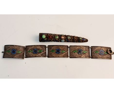 A Chinese white metal and enamel finger guard, converted to a brooch, with a feligree patterned link bracelet, approx. length
