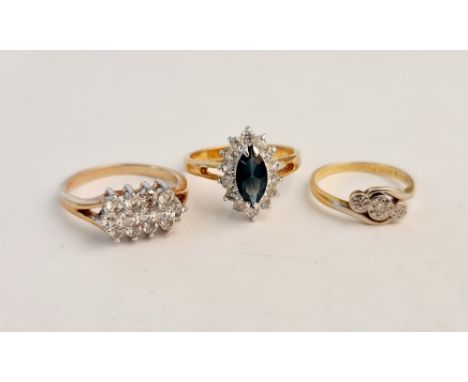 A marked 18ct PLAT three stone diamond ring, ring size K, a yellow metal gem set cluster ring, ring size P 1/2, and a yellow 