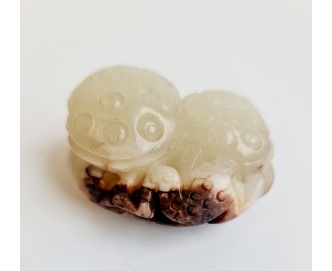A pale green jade to russet frog on lotus leaf. Approx 6cm.