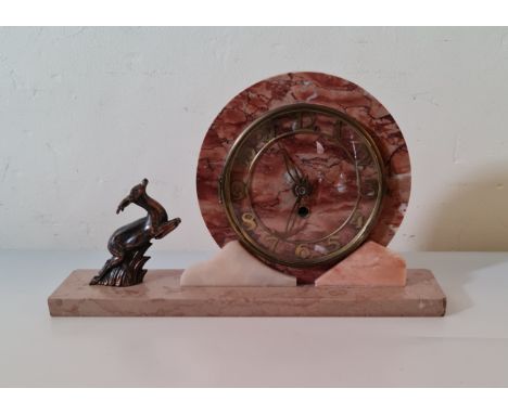 A marble Art Deco mantle clock with round face and metal deer to side. 23 cm 40 cm.