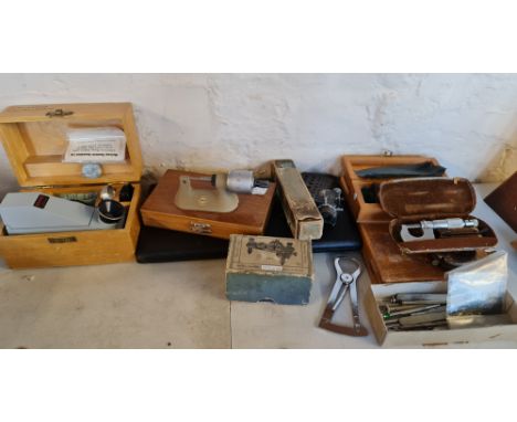 A collection of jewellery making tools and a box of watch parts.