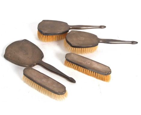 Five piece silver mounted dressing table wares to include hand mirror, two hair brushes and two clothes brushes each with eng