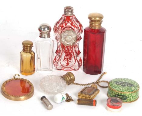 A vintage red velvet and brass box containing seven various scent bottles, an oval gilt framed pendant, together with vintage