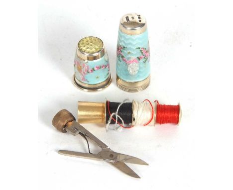 Vintage enamel sewing necessaire, it unscrews to reveal a metal spoof for thread, the top section a thimble, the body with tw