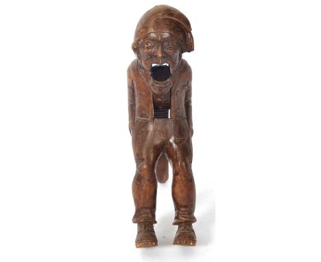 A vintage Black Forest nut cracker, circa 1930 of figural form showing a seated older man with a hat, 21cm overall
