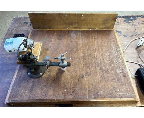 An electric watchmakers lathe along with stamps and tools