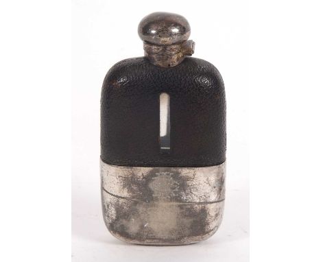 An antique silver plated and leather hip spirit flask having hinged lid, viewing level window and pull off drinking cup, engr